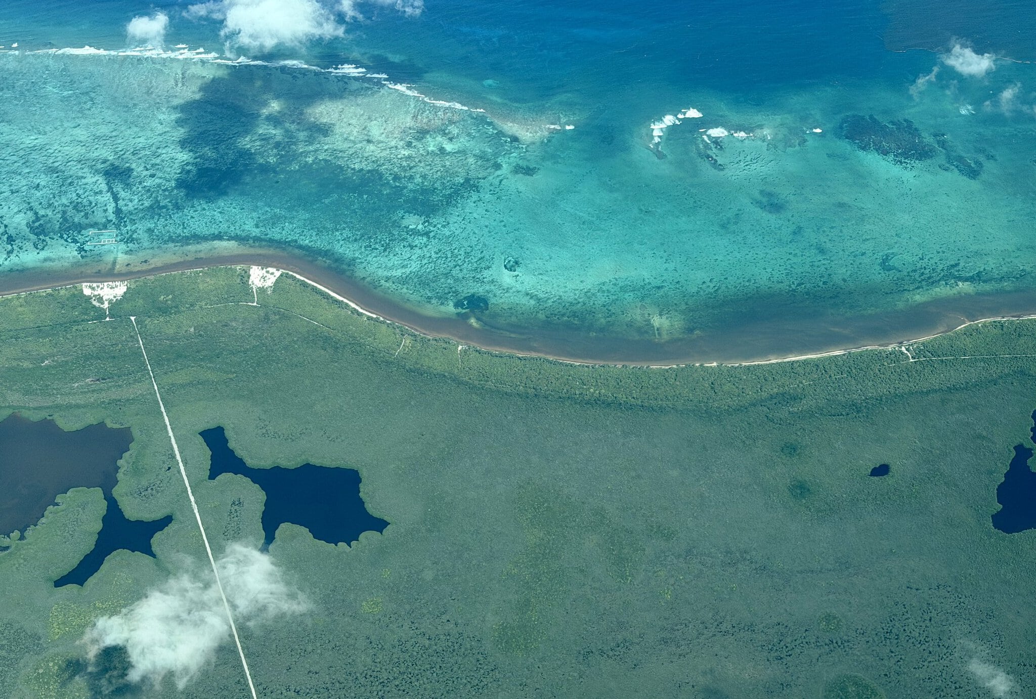 Aerial view of the Flying over Mexico's coastline and the coastal lagoons - Laguna de Uvero and El Cinco.