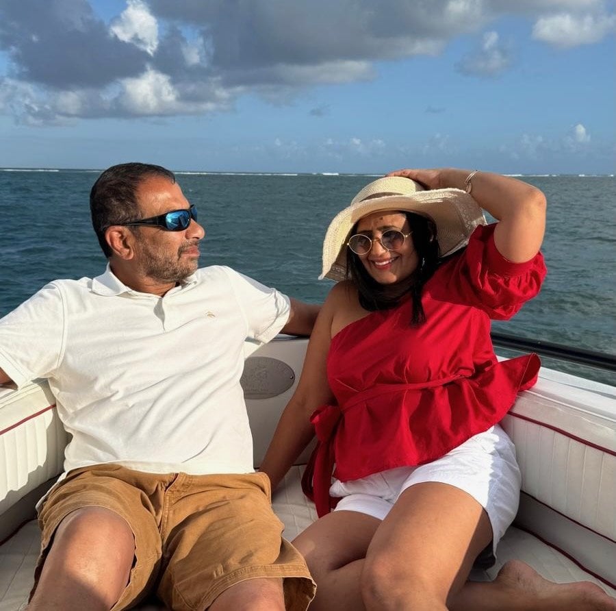 A couple relaxing on the bow of a sunset cruise boat on the Caribbean Sea near San Pedro, Belize