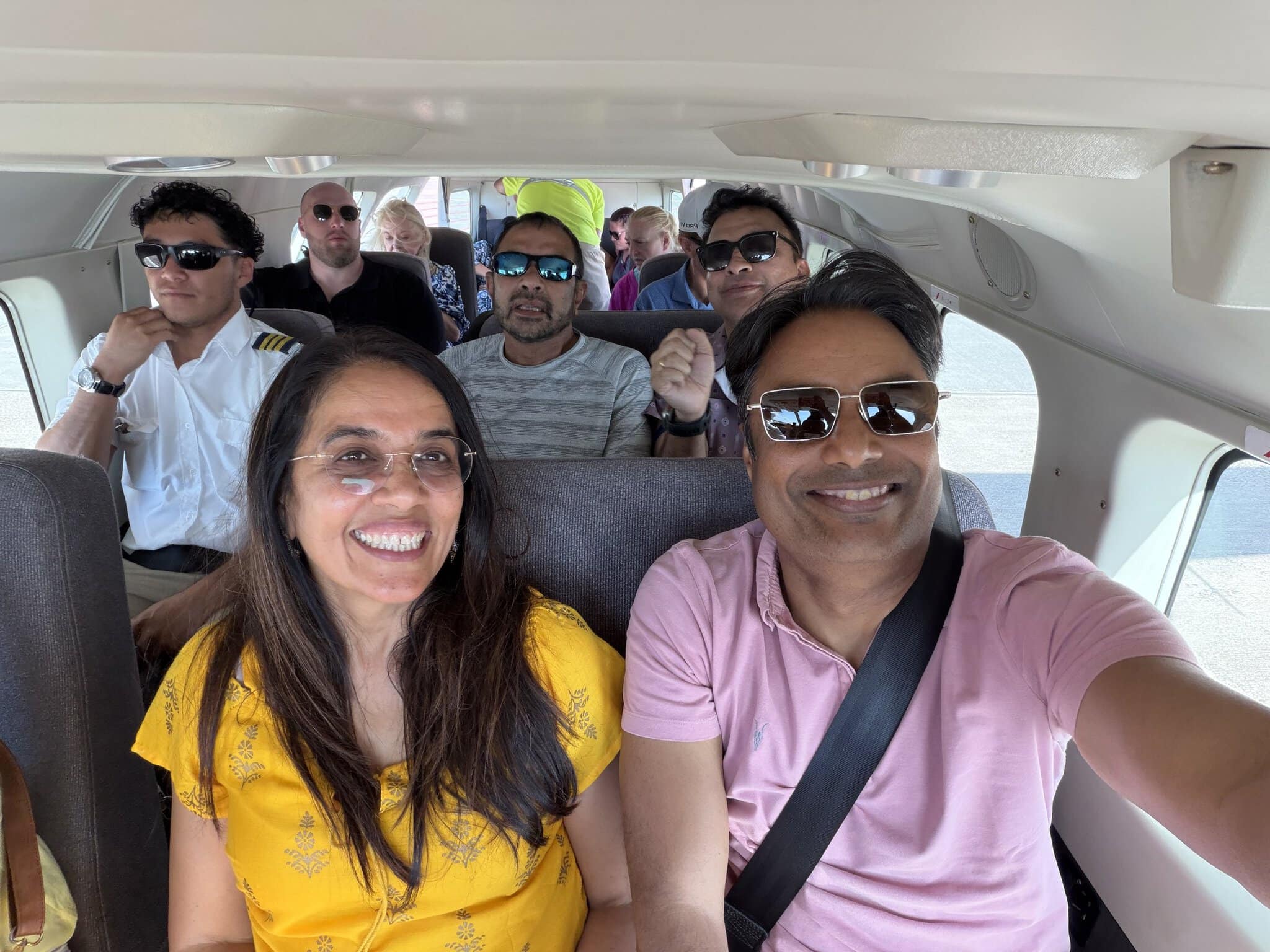 Interior of the Tropic Air 12-seater propeller plane from Belize City to San Pedro, showing passengers and the pilot