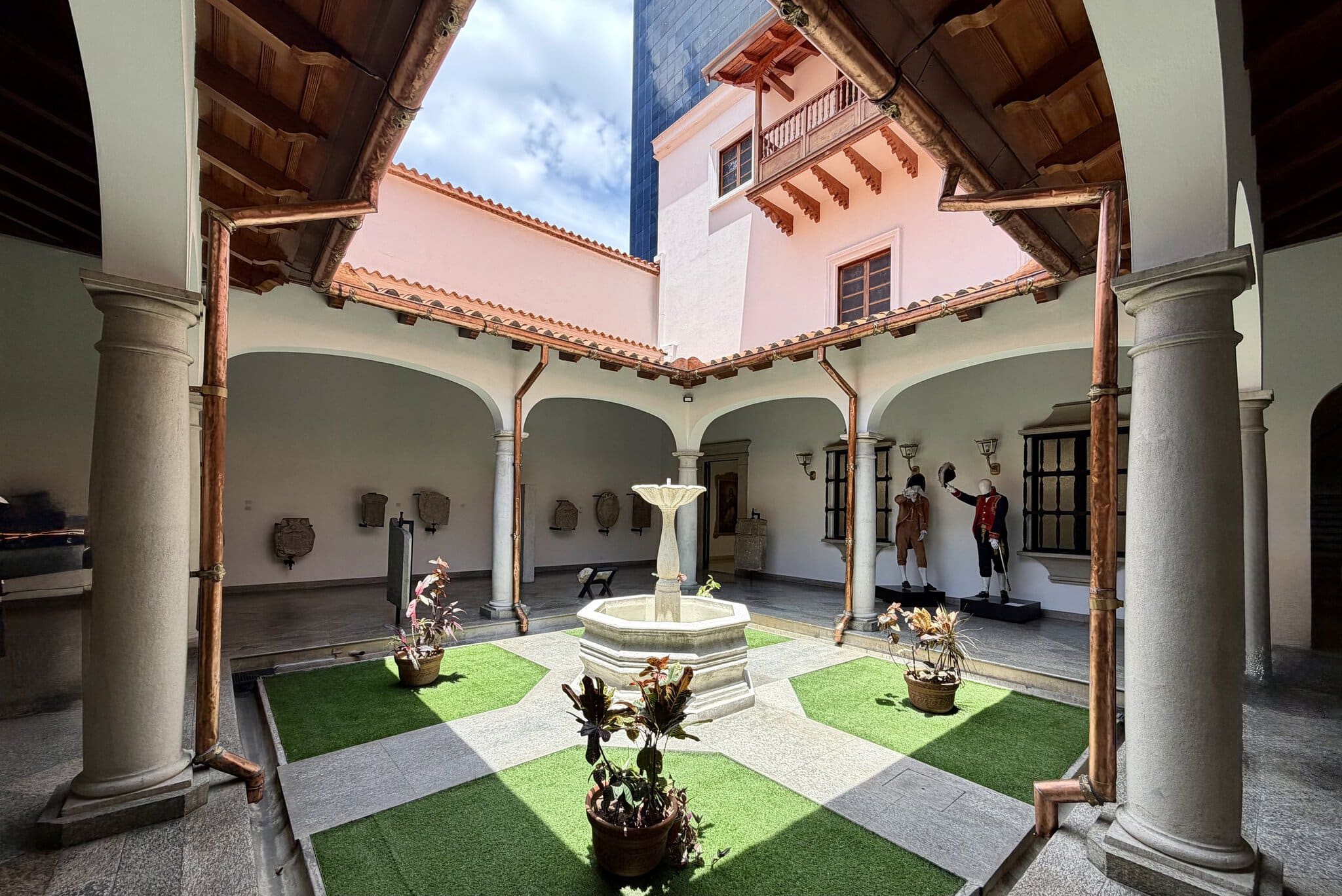 Colonial courtyard with fountain and period mannequins at Casa Natal de Simon Bolivar in Caracas