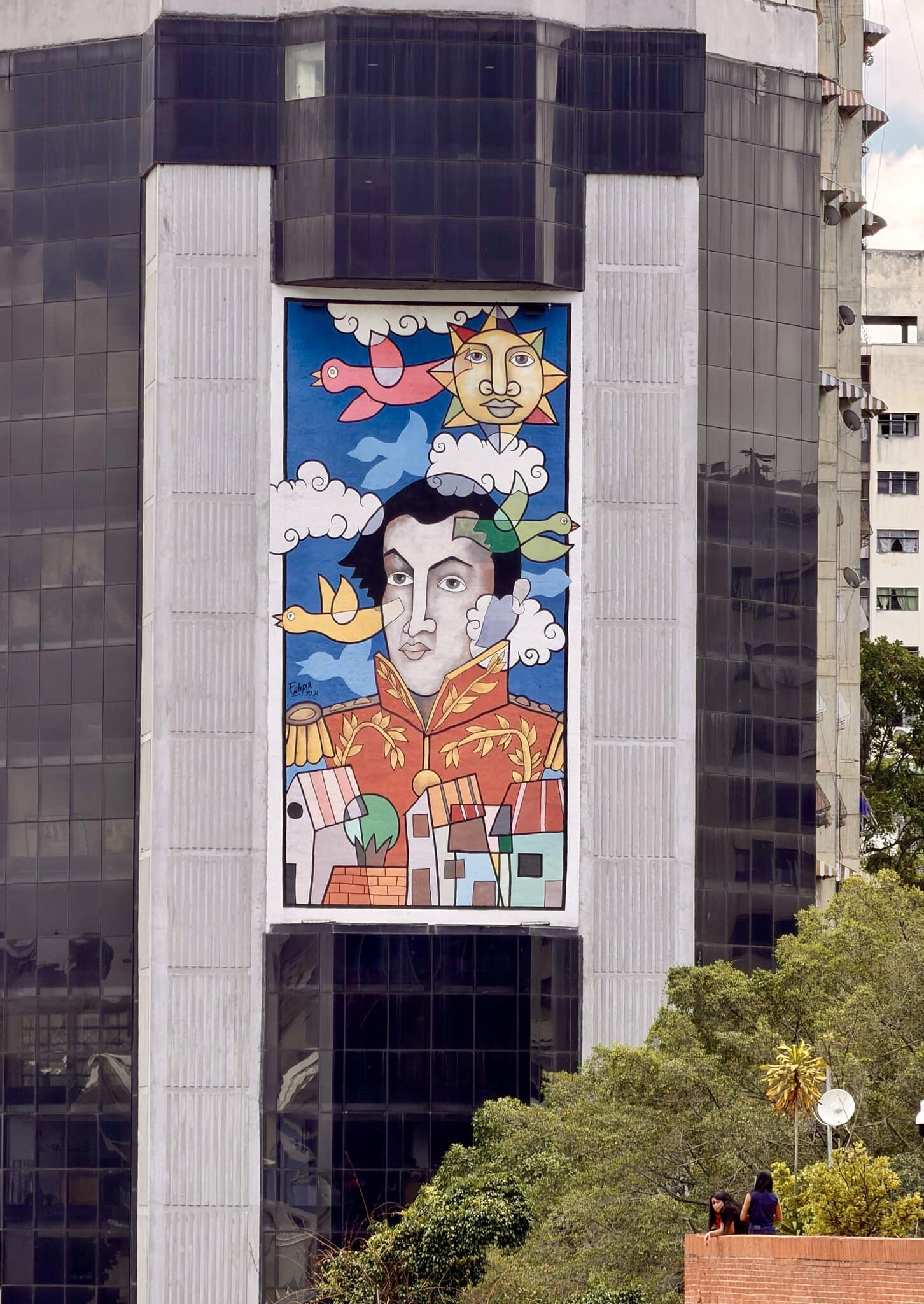 Vibrant pop-art style mural of Simon Bolivar in military uniform on a Caracas skyscraper facade